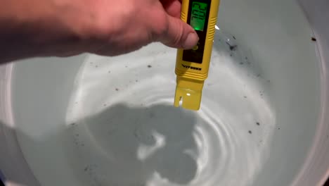 Checking-the-clear-water-PH-levels-before-using--close-up-slowmo