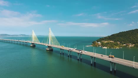 Amazing-bridge-above-turquoise-color-ocean-aerial-view-sunny-day,-located-in-Laguna,-Santa-Catarina,-Brasil