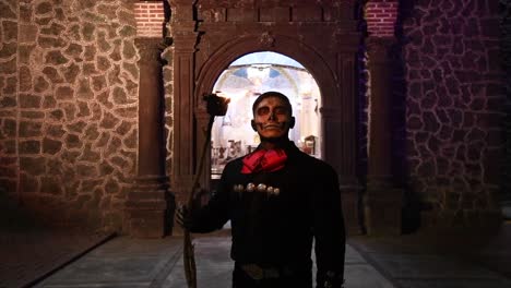 Man-on-day-of-the-dead,-characterized-as-a-black-charro-with-a-torch