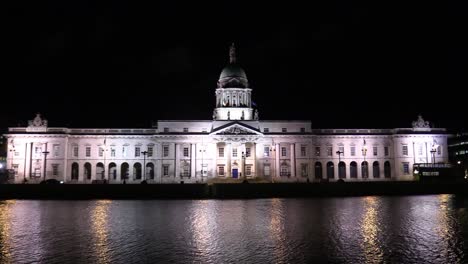 Still-shot-of-the-Irish-Custom-House-in-November-fully-illuminated-with-lights-with-river-Liffey
