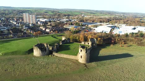 Ancient-Flint-castle-medieval-heritage-military-Welsh-ruins-aerial-view-landmark-pull-back