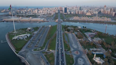 Sharjah-From-the-Top,-Aerial-view-of-Sharjah-city-and-Khalid-lake,-Flag-Island-on-a-beautiful-evening,-urban-traffic-movement-on-the-bridge,-Travel-tourism-business-in-the-United-Arab-Emirates