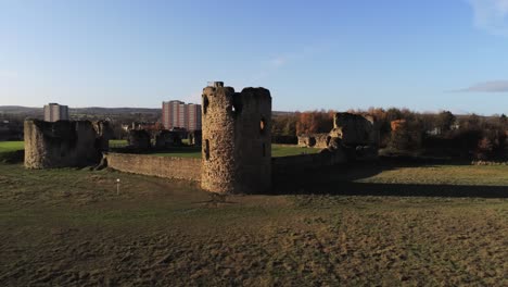 Ancient-Flint-castle-medieval-heritage-military-Welsh-ruins-aerial-view-landmark-slow-forward-push-in