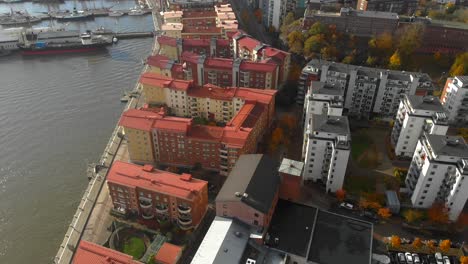 Aerial-view-of-tall-apartment-buildings-rooftops-near-the-sea-port-in-Eriksberg,-Gothenburg