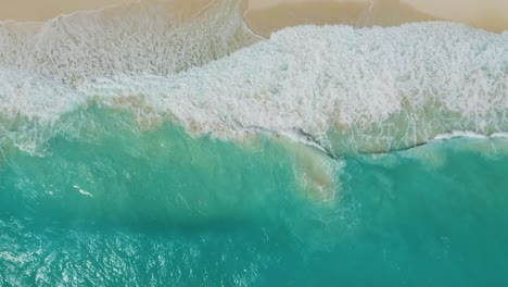 Drone-Descends-as-Waves-Crash-on-Tropical-White-Sand-Beach
