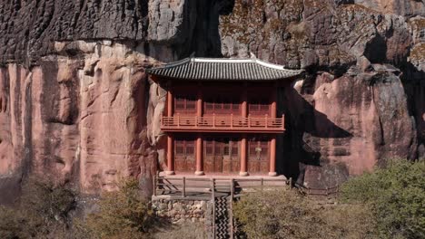 Beautiful-Buddhist-monastery-built-into-mountainside,-Shibaoshan-China,-aerial