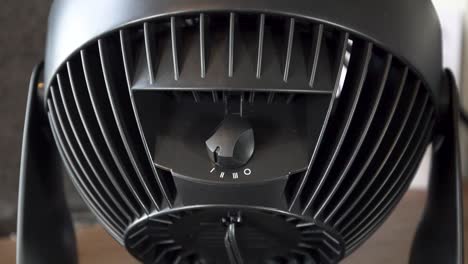 Black-design-electric-fan-on-low-speed--close-up