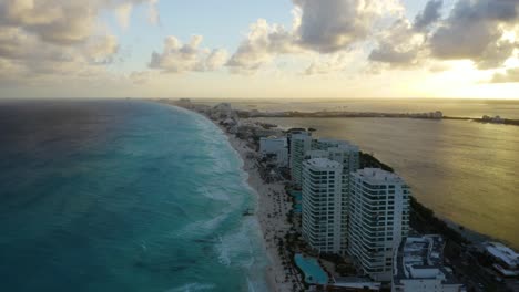 Drone-Flies-Over-Gulf-Of-Mexico-in-Cancun-Hotel-Zone-during-Dramatic-Sunset