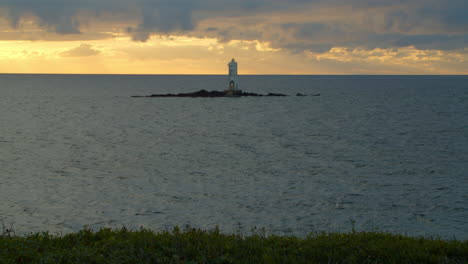 Calasetta-lighthouse-on-small-rock-in-middle-of-sea-against-sunset-sky