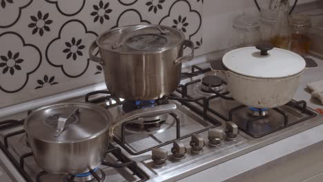 Three-cooking-pots-standing-on-gas-oven-cooker