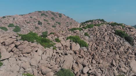 Flying-over-mountain-covered-in-small-and-huge-rocks-in-India