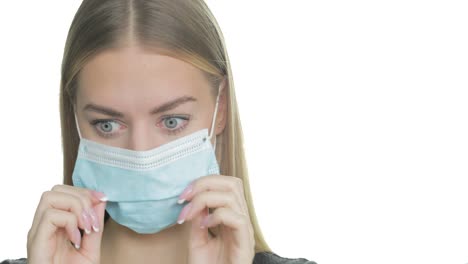 A-woman-struggles-to-breathe-in-her-PPE-mask-and-pulls-it-down-to-take-a-breath