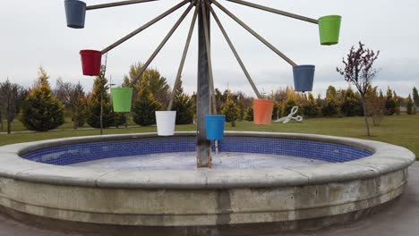 Water-Wheel-with-colorful-Water-Buckets-in-a-Park