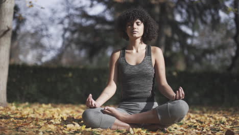 Yoga-self-healing-meditation-by-a-black-woman-at-autumn-season
