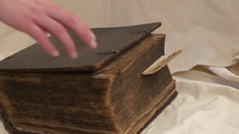 Closing-Old-Historical-Bible,-Slider-Shot,-Close-Up
