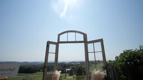 outdoor-wedding-ceremony-location-rustic-boho-chic-decor,-wide-tilt-down-dolly