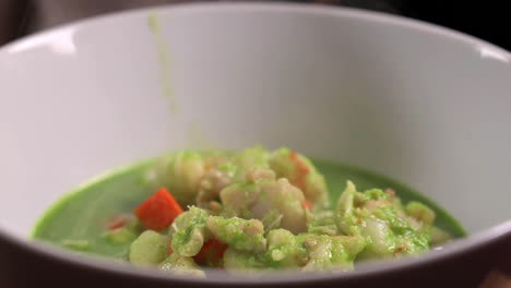 Steaming-Peruvian-Cilantro-Seafood-Soup-In-Bowl---Close-Up,-Slow-Motion