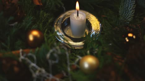 The-woman-lights-a-candle-on-an-Advent-wreath,-the-background-slightly-blurred