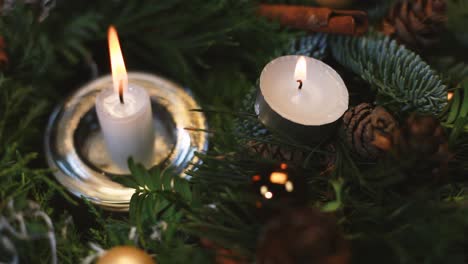 The-woman-lights-a-candle-on-an-Advent-wreath,-the-background-slightly-blurred