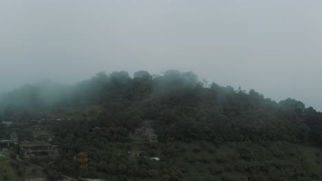 Drone-aerial-flying-towards-misty-cloud-forest-on-the-summit-of-green-mountain-in-Guatemala