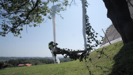 swing-hanging-from-tree-as-wedding-decoration-on-sunny-day,-wide-dolly-forward