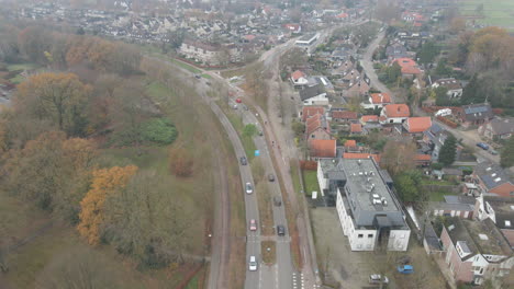 Aerial-of-traffic-driving-over-busy-road-in-small-city