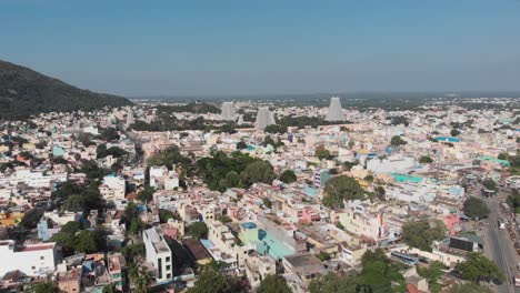 Aerial-flyover-colorful-city-in-India-with-famous-temple-in-background-during-sunny-day-and-blue-sky