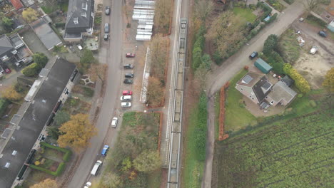 Aerial-of-train-stopping-at-small-rural-train-station