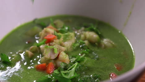Sprinkling-Chopped-Cilantro-Leaves-On-Peruvian-Seafood-Soup