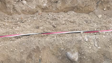 Large-three-strand-power-cable-being-dragged-across-a-construction-site