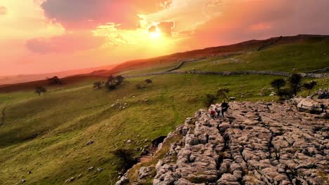Sunset-drone-shot-flying-over-drummer-playing-on-rocks-at-Malham-Cove