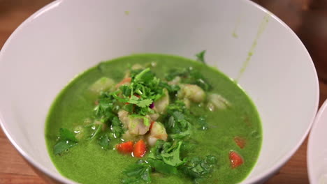 Bowl-Of-Healthy-Seafood-Cilantro-Soup-Served-On-The-Table---zoom-out-shot