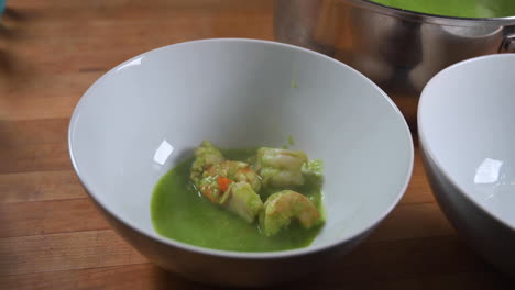Ladling-Cilantro-Seafood-Soup-In-A-Bowl---close-up,-real-time