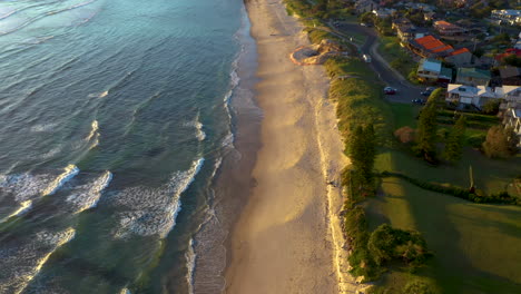 Cinematic-revealing-drone-shot-of-beach-and-ocean-at-Lennox-Head-Beach