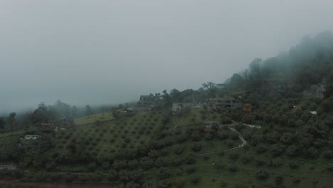 Drone-aerial-flying-over-beautiful-green-hobbit-mountains-during-misty-day-in-Guatemala