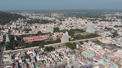 Static-aerial-shot-of-Hindu-Religion-Temple-in-Tiruvannamalai-during-daytime-with-cityscape-and-lake-in-background
