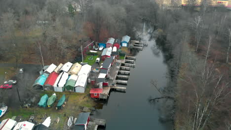 Aerial-footage-of-tiny-inlet-in-Gothenburg-with-boats-and-tiny-huts