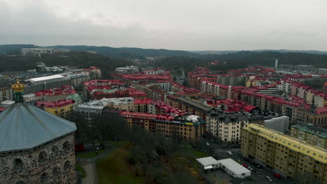 Aerial-shot-of-old-tower-on-hill-overlooking-Gothenburg-city