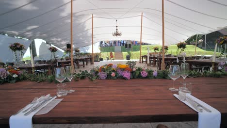 wide-dolly-shot-of-boho-decorated-newlyweds-wedding-table-with-flower-creation