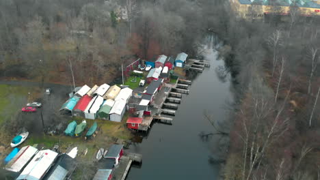 Birds-view-of-tiny-river-with-sheds-and-boats
