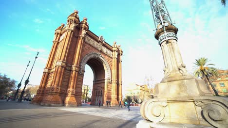 Arco-de-Triunfo-de-Barcelona-and-Statue-with-people-walking-past