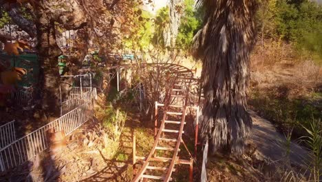 Quick-drone-shot-over-the-rails-of-a-rusting,-abandoned-roller-coaster