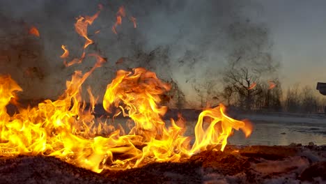Brennende-Ölpest-Schickt-Schwarzen-Schmutzigen-Rauch-In-Den-Himmel,-Während-Die-Sonne-Im-Hintergrund-Aufgeht