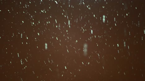 Snow-falling-against-dark-background-of-sky-in-the-night