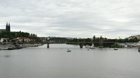 Low-aerial-push-in-of-bridge-over-Vltava-River-and-Vysehrad-Castle