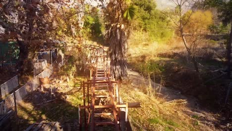 Aerial-over-the-rails-of-a-small,-rusting,-carnival-roller-coaster