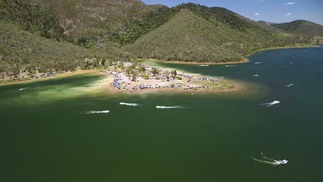 Aerial-Over-Boats-Moving-Past-Near-Coastline-At-Lake-Somerset-In-Queensland