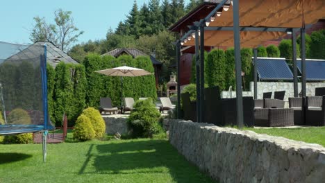 Beautiful-mountainside-wooden-villa-house-in-summer,-view-through-garden