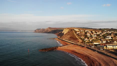 Aerial-rising-view-of-West-Bay-Dorset-England-looking-towards-Charmouth-and-Lyme-Regis