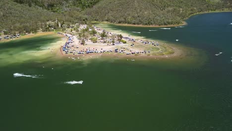 Aerial-Over-Boats-Moving-Past-Near-Coastline-At-Lake-Somerset-In-Queensland